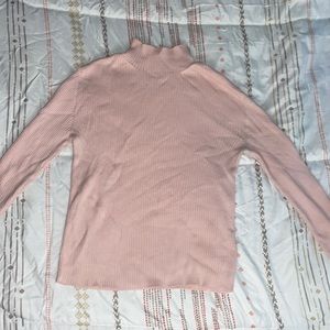 Two turtle neck long sleeve shirts.